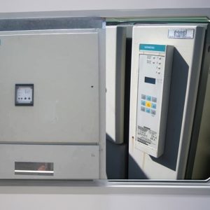 A close-up of a Complete Set Of Secondhand Siemens MV System From A Siemens Power Plant shows its digital display, buttons, and labels on an industrial control panel with the door partially open to reveal the equipment inside.