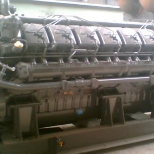 A 1 Set of TBD18V620 Deutz used and repaired Diesel Genset is shown with multiple cylinders and components, mounted on a sturdy metal base in an outdoor setting.