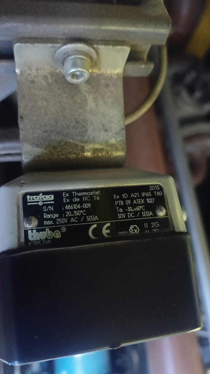 Close-up of a black and silver device label displaying specifications for the SOLD TRAFAG 414 INDUSTAT 1 20 TO 150Grdc/53279 Temperature And Pressure Thermostat, including voltage ratings, temperature limits, and safety certifications. Suitable for heavy industry applications or as an LM2500 spare part, the label provides various technical details and serial numbers.