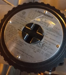Close-up of a round metallic label on used industrial equipment, displaying technical details, WILSON DET-TRONICS brand, certification symbols, and serial numbers—typically seen on a Gas Analyser Transmitter (5 Each).