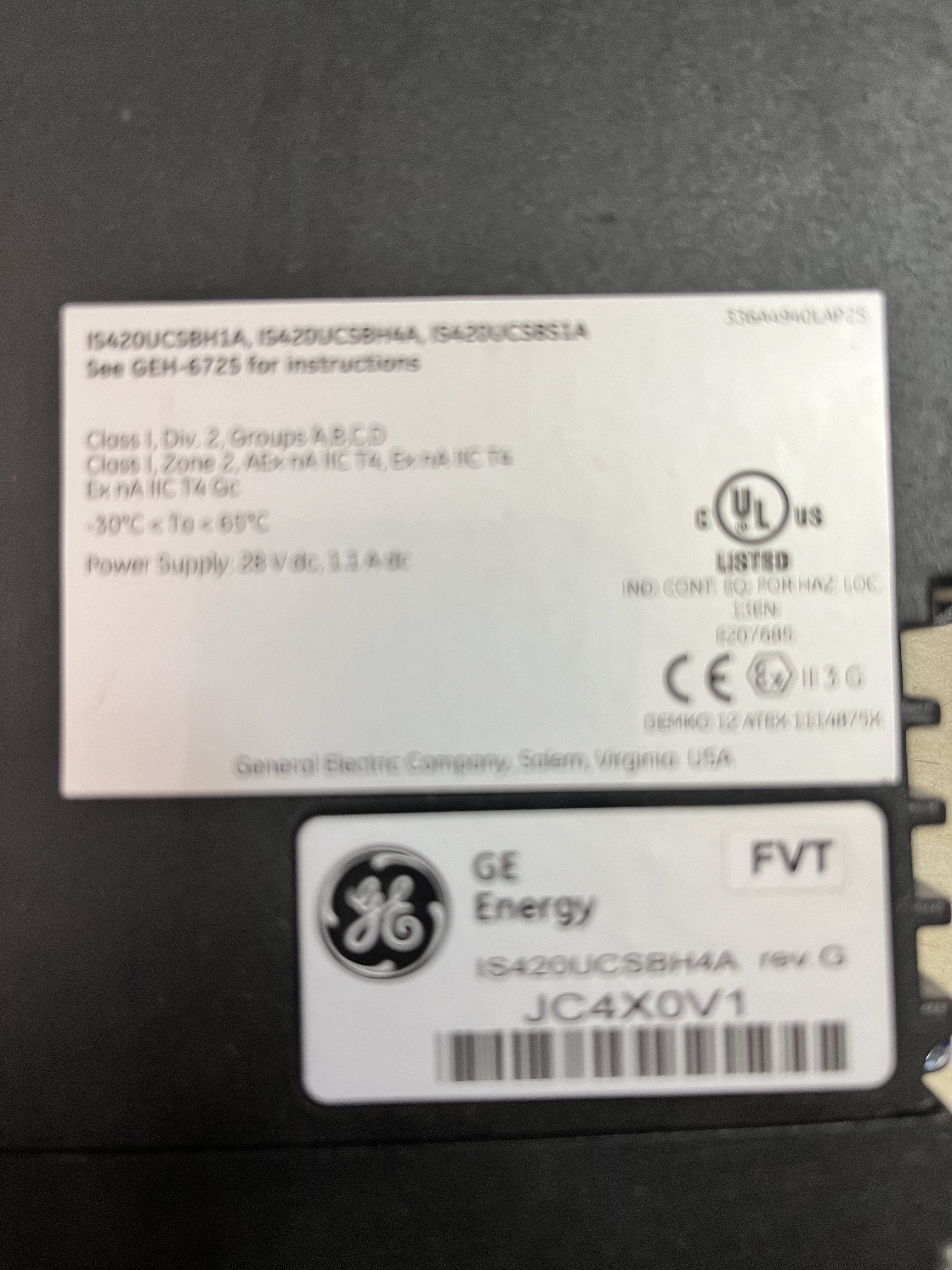 A close-up of a GE Energy IS420UCSBH4A UCSB CONTROLLER MODULE label displays technical data, barcodes, and the General Electric logo. This used LM6000 spare part label shows electrical ratings, certifications, and manufacturer details.