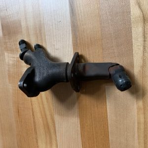 A refurbished Dual Fuel L31421P10 Nozzles set for LM2500 Gas Turbine, made of dark metal with two hose connections and a mounting flange, is displayed on a light wooden surface.
