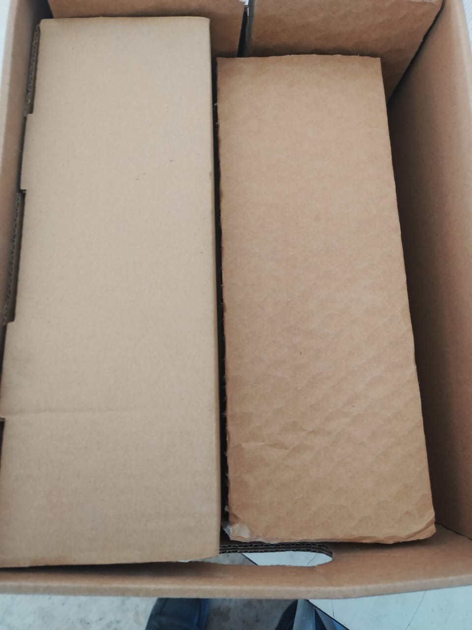 A top-down view of a cardboard box with three neatly arranged brown packages, each labeled as Sold 3 pcs OBSOLETE GE FENRD/5 Door Mounted Extended Rotary Handle for GE Circuit Breaker.