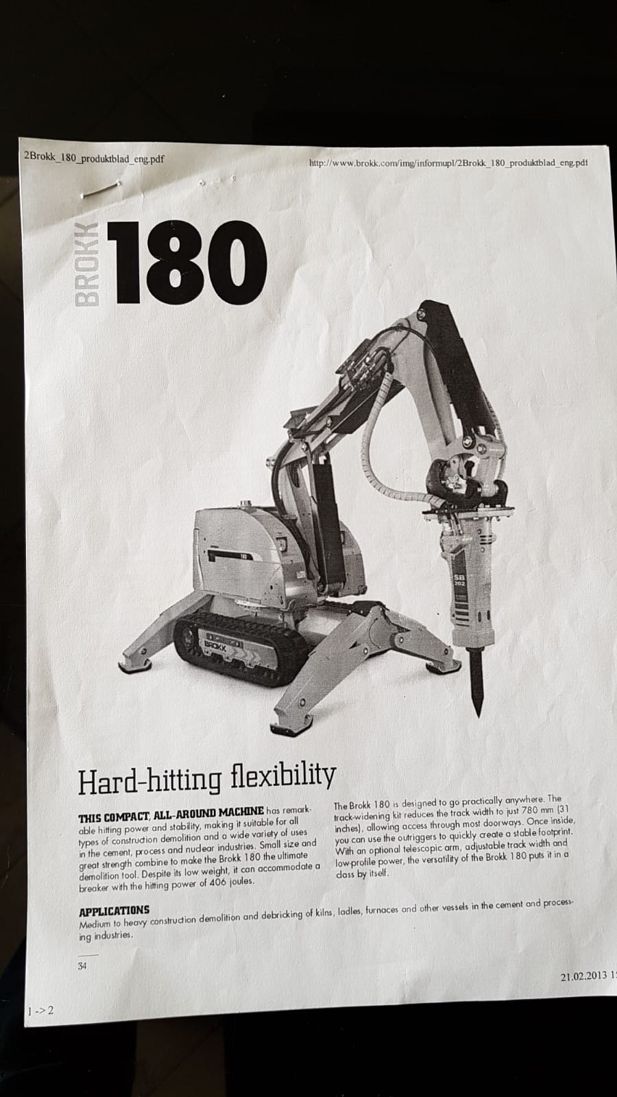 A brochure page presents the DEMOLISHING UNIT BROKK 180 REV-F1, a compact tracked demolishing machine with a mechanical arm and versatile attachments. The headline Hard-hitting flexibility is featured, along with product details and applications.