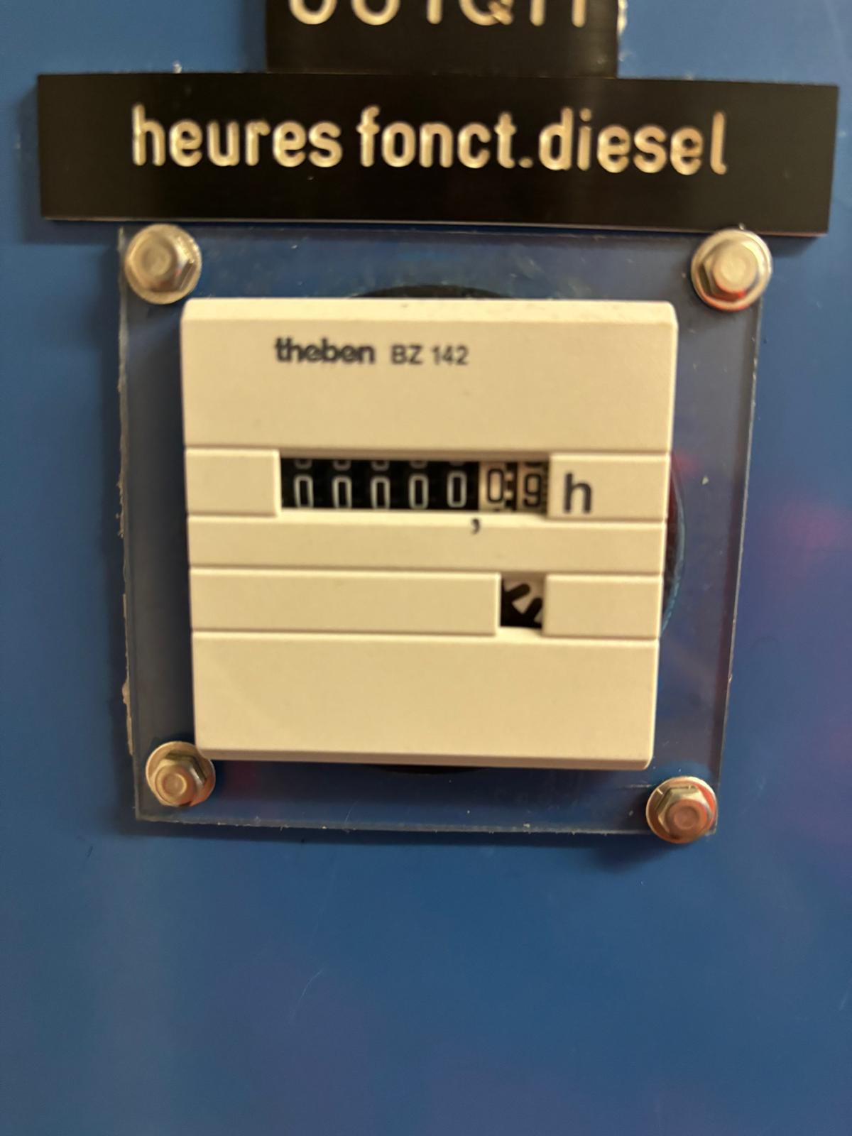 A close-up of a Theben BZ 142 hour meter reading 0.9 hours, mounted on a blue panel with a label above that reads heures fonct.diesel.