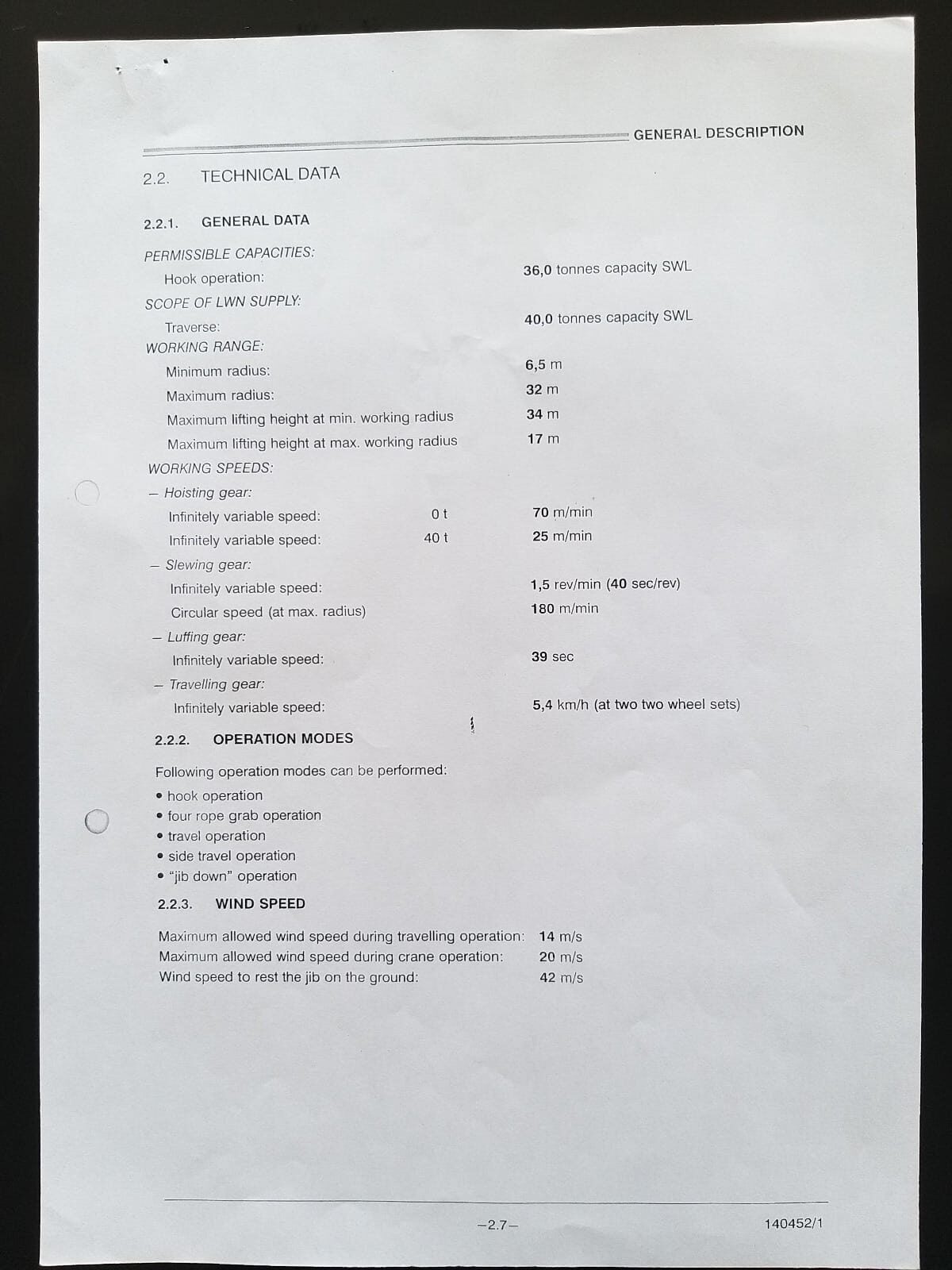 A printed technical data sheet on a table, listing specifications such as power supply, working temperature, humidity range, and measurement units for an unspecified device. The document is positioned at an angle.