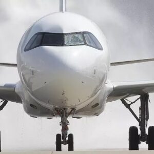 A front view of a commercial airplane on the runway with water spraying in the background, possibly during a celebratory water salute for new SURPLUS STOCK AVAILABLE FOR SALE: Airbus A320, A319, ATR72 Component Tyre EATON products, Boeing 737 fleet.