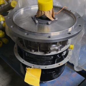 A Gas Turbine Gearbox with Starter and Oil Separator, featuring a round top, yellow protective caps, and a yellow tag, sits on a blue surface with plastic wrapping and other yellow-capped parts in the background.